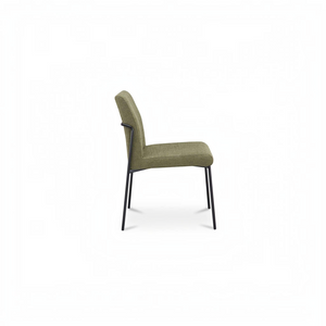deKor set of two green upholstered dining chairs with curved iron frames and padded seats in a side profile view.