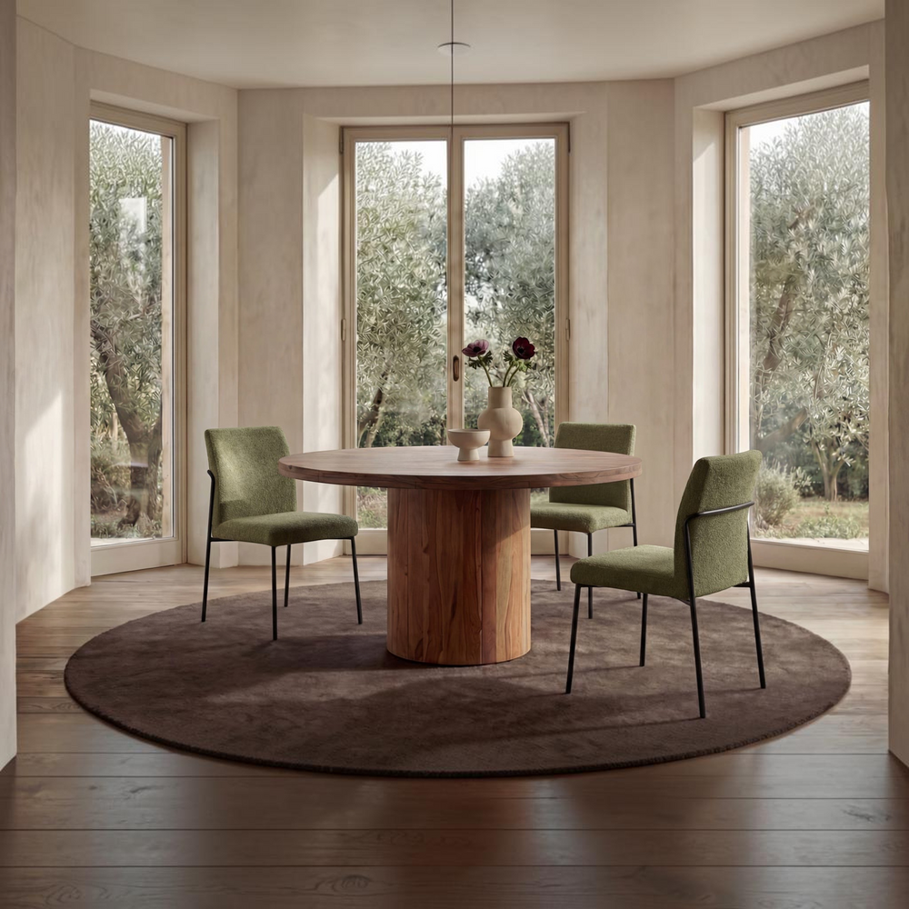 Set of two deKor dining chairs with green upholstered seats and minimalist black curved iron frames.