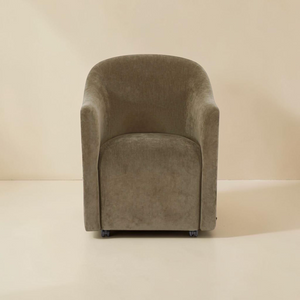 deKor green textured polyester rolling barrel dining chair with a curved back and comfortable foam padded seat.