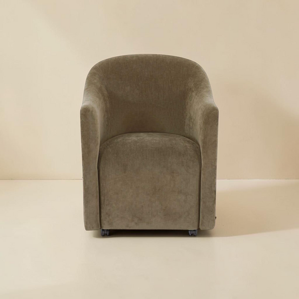 deKor green textured polyester rolling barrel dining chair with a curved back and comfortable foam padded seat.
