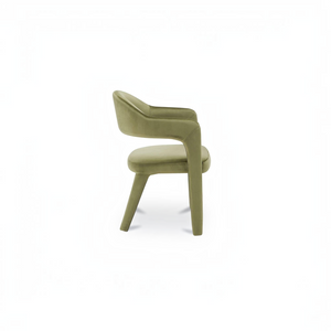 deKor barrel back dining chair in green velvet with a continuous curved frame and comfortable padded armrests.