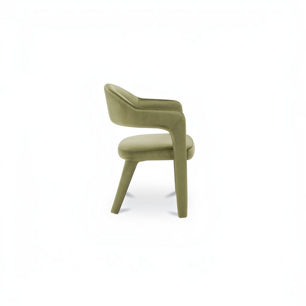 deKor barrel back dining chair in green velvet with a continuous curved frame and comfortable padded armrests.