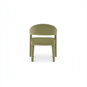 deKor barrel back dining chair upholstered in sage green velvet with a continuous curved frame and armrests