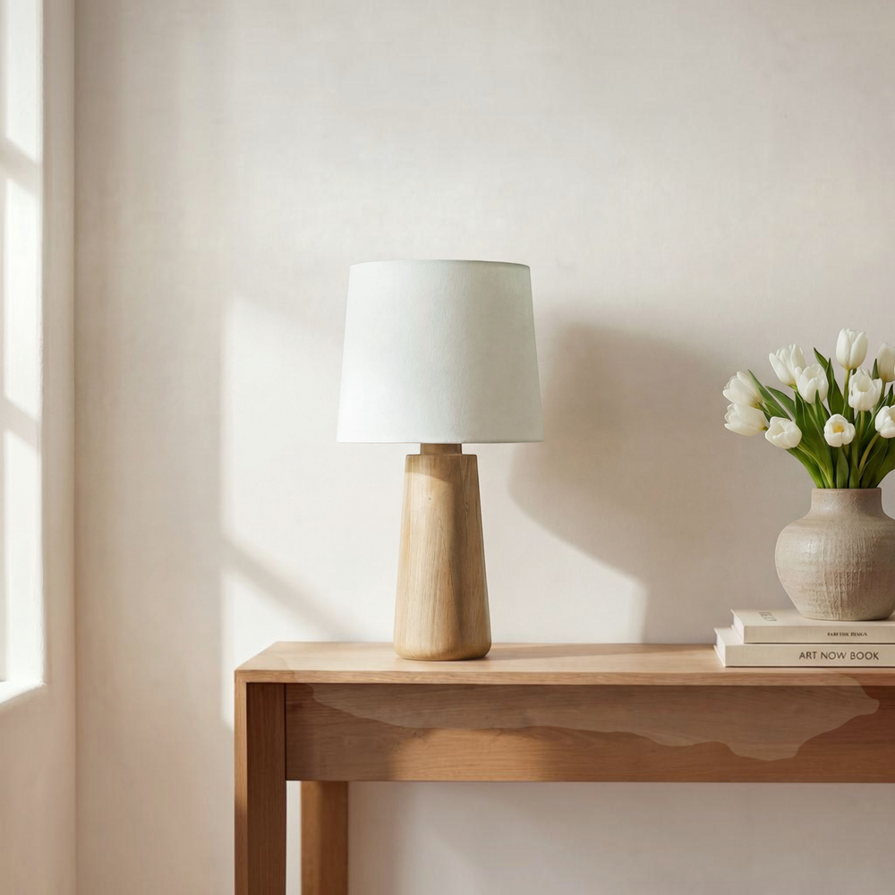 deKor table lamp with a solid natural mango wood base and a white fabric drum shade for soft ambient lighting.