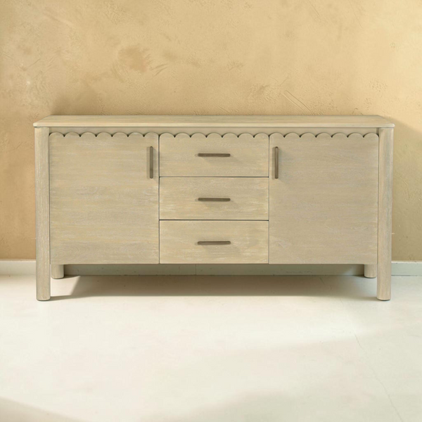 deKor natural wood sideboard featuring a scalloped edge, three central drawers, two side cabinets, and round legs.