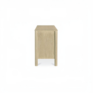 deKor natural wood sideboard with scalloped edge detail and round legs, shown from a side profile view.