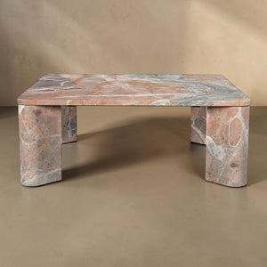 deKor Segment coffee table in orange Levante marble with a smooth surface and unique angular segmented base design.