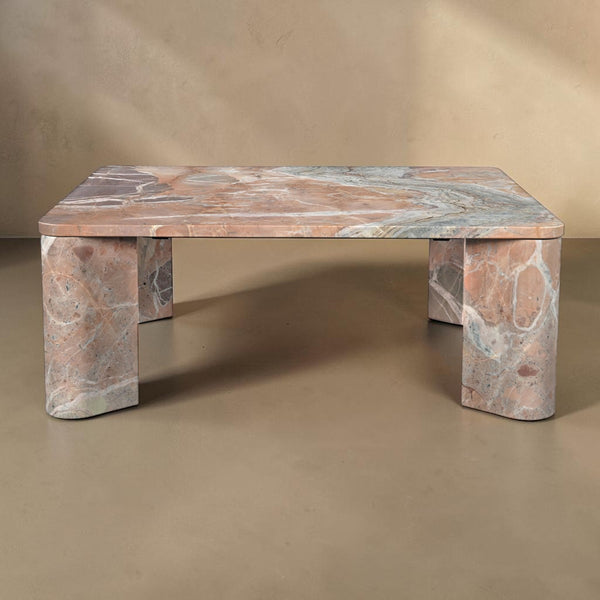 deKor Segment coffee table in orange Levante marble with a smooth surface and unique angular segmented base design.