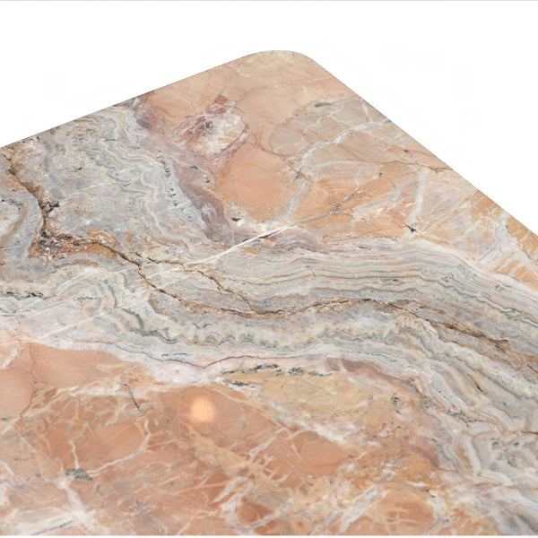 Close-up of deKor orange Levante marble coffee table surface showing intricate natural stone veining and soft edges.