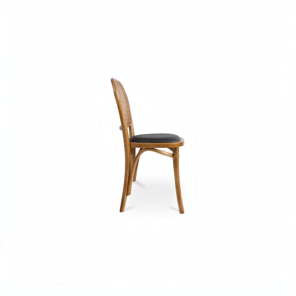 deKor rattan dining chair with a natural wood frame and a dark black polyurethane seat, side profile view.