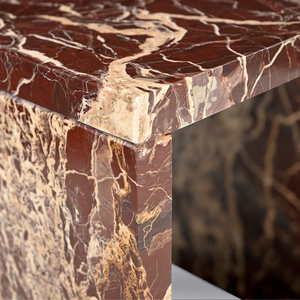 deKor Rosso Levanto marble accent table featuring a waterfall design with vibrant red stone and striking gold veining.