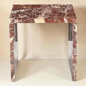 deKor Rosso Levanto marble accent table featuring a bold waterfall design with vibrant red stone and gold veining.