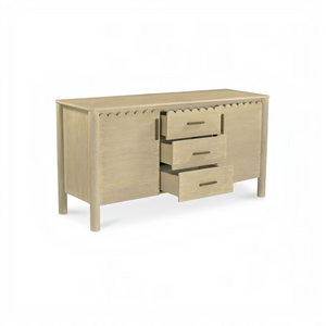 deKor natural wood sideboard with scalloped edge detailing, three drawers, and round legs in a Scandinavian style.