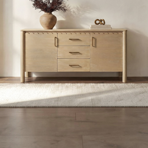 deKor natural wood sideboard with scalloped edges, three central drawers, two cabinets, and minimalist iron handles.