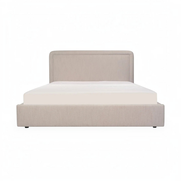 deKor Simon storage bed in beige fabric with a rounded headboard and piped detailing, front view.