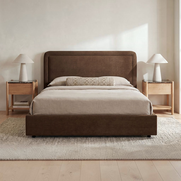 deKor Simon storage bed in dark brown fabric with a rounded headboard and piped detailing in a modern bedroom setting