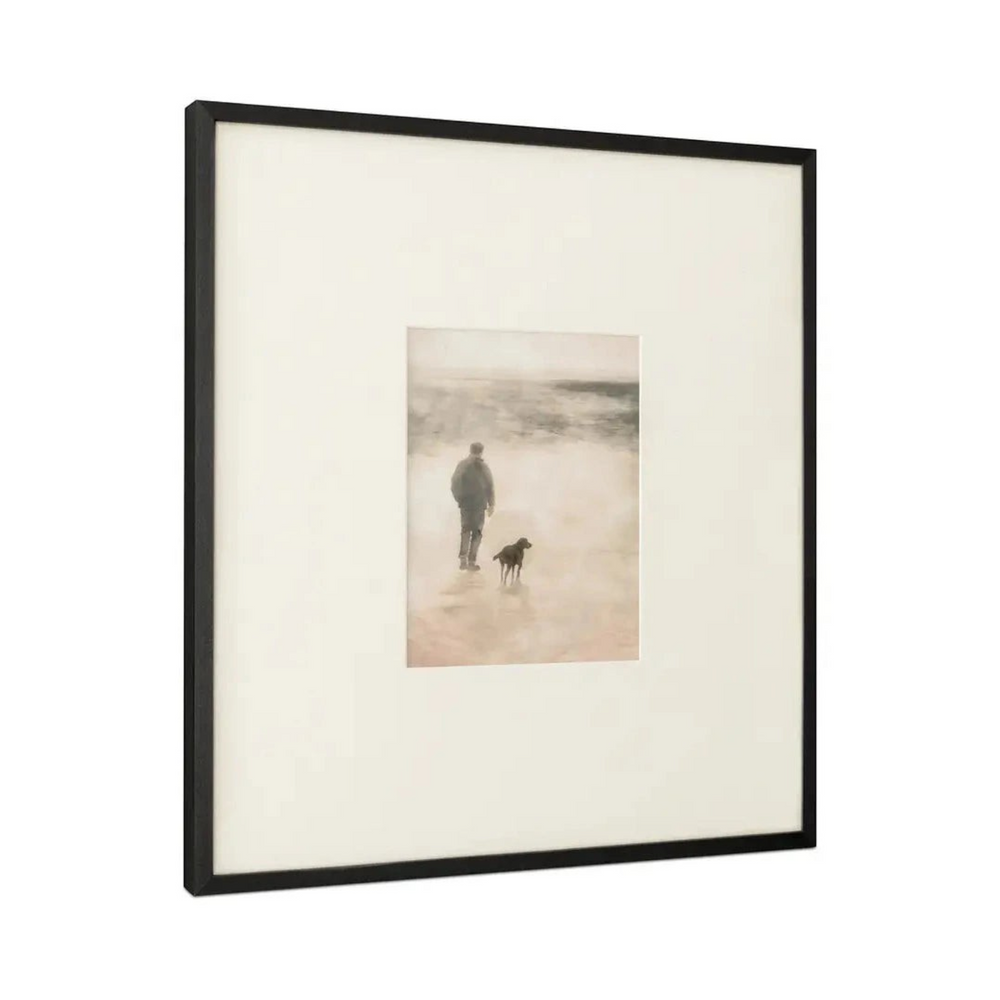 deKor Strand 1 framed print featuring a man and dog walking on a misty Irish shore with an earthy tone matte border.