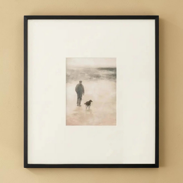 deKor Strand 1 framed print featuring a man and dog walking on a misty Irish shore with an earthy tone matte border.