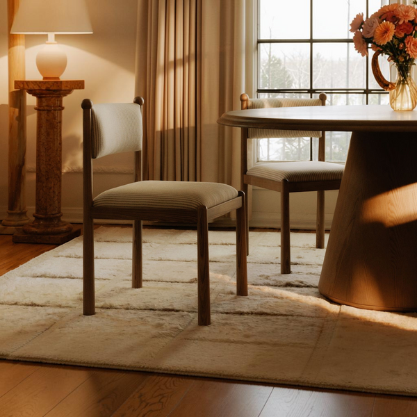 deKor Villetta dining chairs with striped upholstery and warm stained wood frames in a vintage-inspired dining room.
