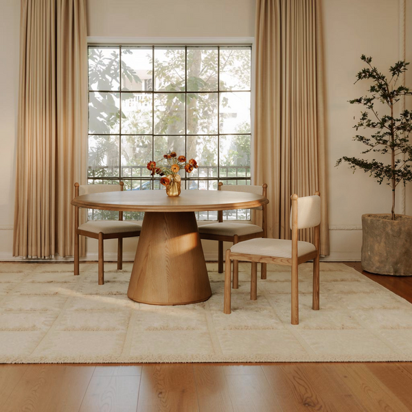 deKor Villetta dining chairs with striped fabric and warm stained wood frames in a sunlit vintage-inspired dining room