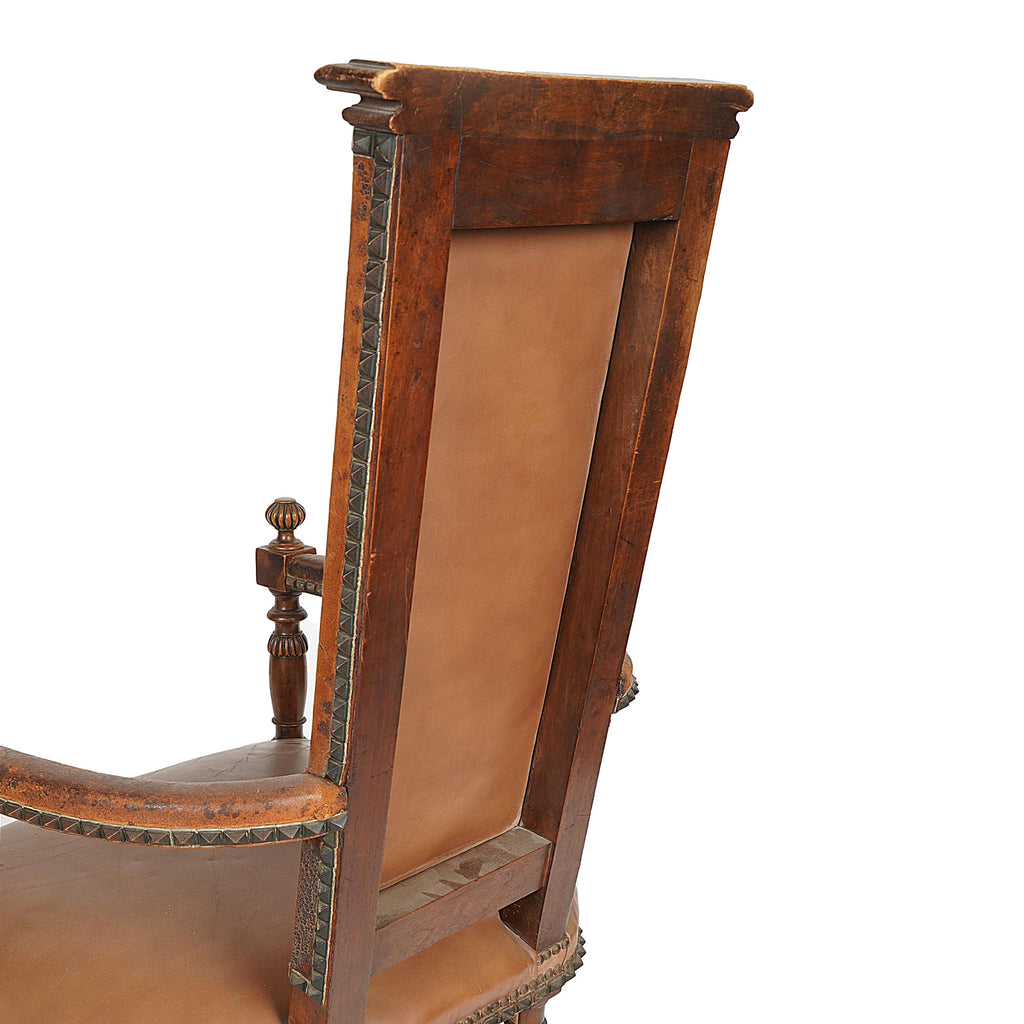 carved wood chair with iron and leather detailing 