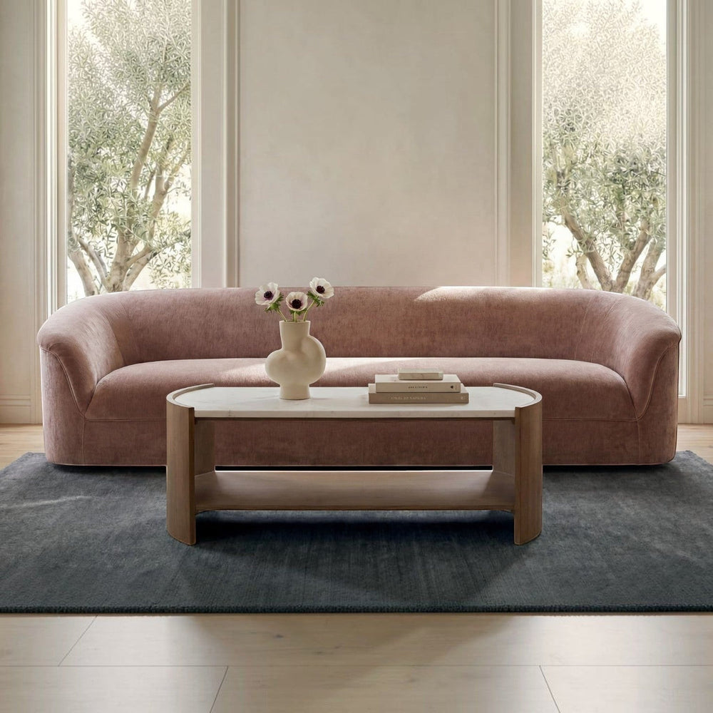 deKor blush velvet-like rolled arm sofa with a fixed back and sink-in foam cushioning in a minimalist room setting