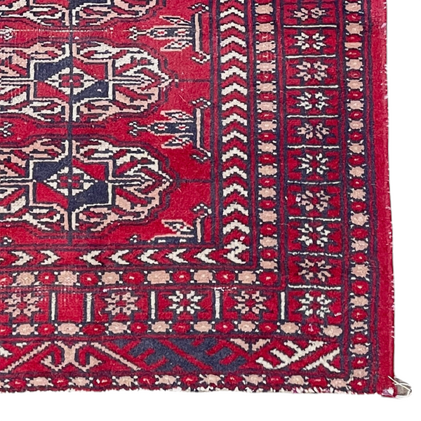 Vintage red Turkmen accent rug with blue and white decoration