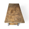 tabletop view of a french farmhouse style work table with a drawer, lower shelf and distressed gray paint