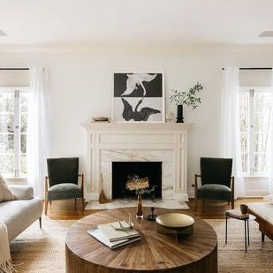 green velvet occasional chairs at fireplace with round coffee table 