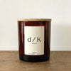 deKor d/K Organic Candle in an amber color glass jar with a wooden lid