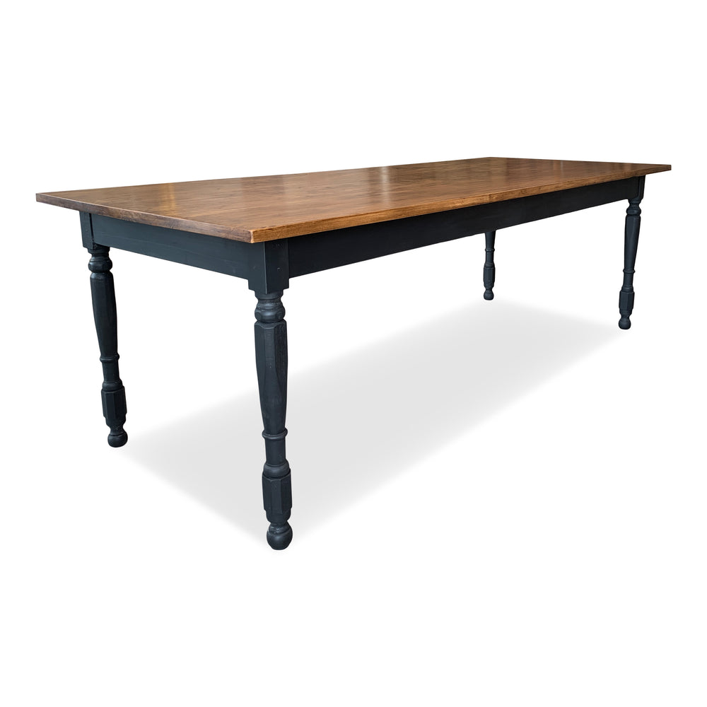 Hardwood farm table with natural finished alder wood top and black painted turned legs. 