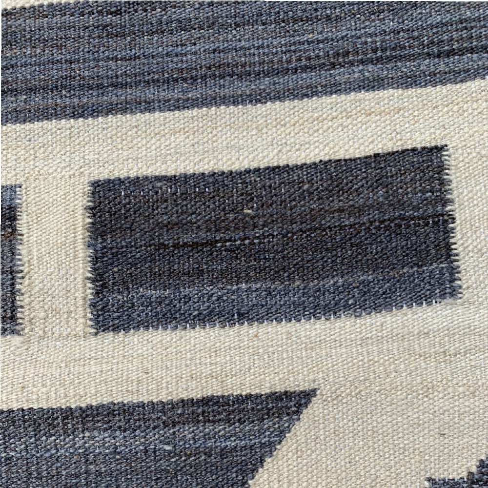 close up of flat weave grey and off white Swedish area rug