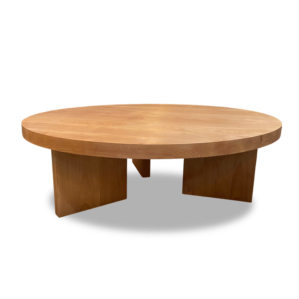 midcentury style alder wood round coffee table on block legs in a light natural finish